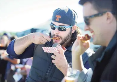  ?? Hearst Connecticu­t Media file photo ?? Jason Pfalzgraf, of Milford, samples the mango barbecued wings from the Dew Drop Inn, on Oct. 10, 2015 during the 3rd Annual Hoptoberfe­st Craft Beer and Wing Festival at the Shelton Riverwalk.