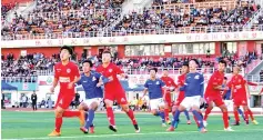  ?? — AFP photo ?? This photo taken on September 24, 2017 shows players of Lhasa Chengtou (in blue) and Zibo Sunday (in red) competing for the ball during their 2017 Chinese Football Associatio­n Amateur League football match at the People's Cultural and Sports Center,...