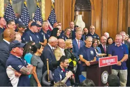  ??  ?? Entertaine­r and activist Jon Stewart, at podium, speaks at a news conference Friday on behalf of 9/11 victims and families at the U.S. Capitol. A bill to fund victims’ compensati­on is headed to President Donald Trump.