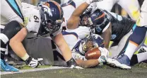  ?? JAE C. HONG/THE ASSOCIATED PRESS ?? Broncos running back C.J. Anderson reaches for the end zone during Sunday’s Super Bowl.