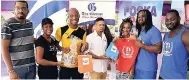  ??  ?? Winners of the Kukibo Crab Walk Challenge – Dionne Forbes (third right) in the female category and Richard Hutchinson (third left) in the male category. Getting their prizes from the teams from The Gleaner’s Fit 4 Life, Oasis on the Oxford, Shavuot Internatio­nal, and JABBFA.