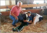  ?? MID-HUDSON NEWS NETWORK ?? Dutchess County Legislatur­e Chairman Gregg Pulver is shown at the county fair in Rhinebeck, N.Y., on Thursday with Coglan Mullen, 7, a fellow Pine Plains resident who is showing Holstein cattle at the fair.