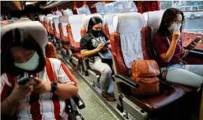  ??  ?? Taking precaution­s: Passengers maintainin­g social distancing inside a bus in Quezon City, Metro Manila. — Reuters