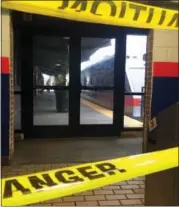  ?? ANTHONY IZAGUIRRE — THE ASSOCIATED PRESS ?? Police tape blocks off a train track at the 69th Street Terminal in Upper Darby, Pa., after a train collision early Tuesday injuring dozens of passengers. A regional rail train crashed into a parked train at the suburban Philadelph­ia terminal, a...