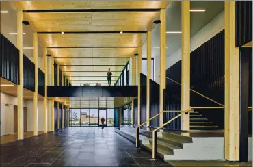  ?? BENJAMIN BENSCHNEID­ER VIA THE NEW YORK TIMES ?? A view inside the Catalyst building in Spokane, Wash., the newest of 384 large mass timber buildings in the U.S. Developers are turning to laminated panels, beams and columns, what the industry calls mass timber, for constructi­on.