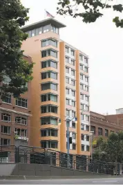  ??  ?? The 159-room hotel is clad mainly in tiles of earthy terra-cotta and topped by a narrow crown.