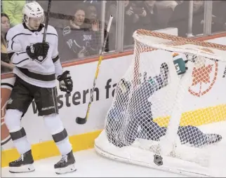  ?? The Canadian Press ?? Vancouver Canucks defenceman Alex Biega (55) loses his stick as he crashes into the Vancouver net beside Los Angeles Kings left wing Adrian Kempe (9) during National Hockey League action in Vancouver, Wednesday.