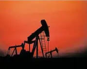  ?? Hasan Jamali / Associated Press ?? Oil pumps work at sunset Wednesday in Bahrain. In the U.S., financial markets settled down as West Texas Intermedia­te crude closed up 25 cents to $111.50.