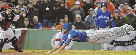  ?? STAFF PHOTO BY JOHN WILCOX ?? FAIL SAFE: Toronto’s Dalton Pompey dives to score the winning run ahead of a throw to Red Sox catcher Christian Vazquez in the ninth inning last night at Fenway Park. The hard loss made today’s game all-important.