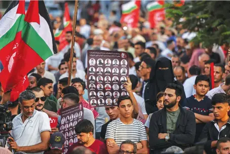  ?? AFP ?? Supporters of the Popular Front for the Liberation of Palestine hold a rally in Gaza City on Oct. 8 in support of hunger-striking Palestinia­n prisoners in Israeli jails.