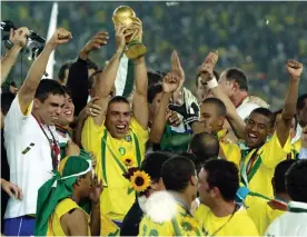  ?? Photograph: Kai Pfaffenbac­h/Reuters ?? Ronaldo holds up the World Cup trophy after Brazil beat Germany 2-0 in Yokohama in 2002, the occasion of David Lacey’s last match report as football correspond­ent of the Guardian.