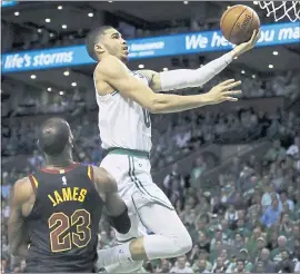  ?? CHARLES KRUPA — THE ASSOCIATED PRESS ?? The Celtics’ Jayson Tatum drives past Cleveland’s LeBron James for two of his 24 points.