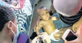  ?? AP ?? A baby is given an IV at the La Paix Hospital, also known as the University of Peace Hospital, lit with the aid of a cellphone flashlight amid severe fuel shortages and a continued general strike in Port-au-Prince, Haiti on Tuesday. A bone doctor at the hospital said the facility only has a few more days of fuel to keep operating.