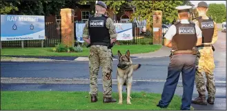  ??  ?? Terror threat: Military police on guard outside RAF Marham yesterday