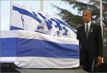  ?? ABIR SULTAN — ASSOCIATED PRESS ?? President Barack Obama looks at the casket of former Israeli leader Shimon Peres during Peres’ funeral Friday at the Har Herzl cemetery in Jerusalem.