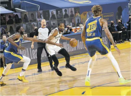  ?? (Photo: AFP) ?? Kevin Durant (centre) of the Brooklyn Nets dribbles the ball during the game against the Golden State Warriors on Saturday at Chase Center in San Francisco, California.