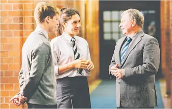  ?? Photo / Supplied ?? Teacher Peter Preston chats with students Leilani Guinea and Timothy Haldane. They will all be a part of Whanganui Collegiate School as it becomes a Round Square School.