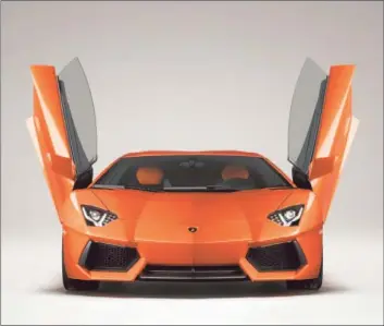  ?? Lamborghin­i ?? WITH A WIDE AND LOW STANCE, Lamborghin­i’s latest V-12 supercar, the Aventador LP 700-4, carries itself with civilized brutality like little else on the road.