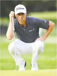  ?? DANIELLE PARHIZKaRa­N/USA TODAY SPORTS ?? World No. 3 Justin Thomas lines up a putt on the first green during Thursday's first round at the U.S. Open, held this year at the challengin­g Winged Foot Golf Club in Mamaroneck, N.Y. Thomas leads the pack after opening with a 5-under-par 65.