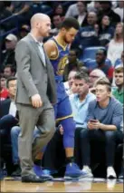  ?? GERALD HERBERT — THE ASSOCIATED PRESS ?? Golden State Warriors guard Stephen Curry, right, limps off the court to the locker room in the second half of an NBA basketball game against the New Orleans Pelicans in New Orleans Monday.