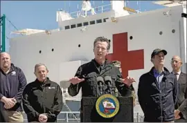  ?? Carolyn Cole Los Angeles Times ?? GOV. NEWSOM spoke last March in front of the hospital ship USNS Mercy after it arrived to boost L.A. hospital capacity. It returned to San Diego in May.