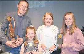  ?? Ahern) (Pic: John ?? TWO TITLES FOR FAMILY GUY JOHN: John Stack, celebratin­g with his talented daughters, Ruby, Molly and Emily at last Sunday’s night’s homecoming party in St. Michael’s Hall, Ballyduff. John was also involved with Ballyduff Drama Group when they won the All-Ireland in 2004 with ‘On Raftery’s Hill’.