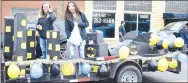  ?? Westside Eagle Observer/MIKE ECKELS ?? Destiny Mejia (left) and Natalia Rodriguez ride the senior class float down Main Street during the 2019 homecoming parade through downtown Decatur Friday afternoon. The theme for the senior float was Batman. It was decked out with a Batmobile and the superhero himself.