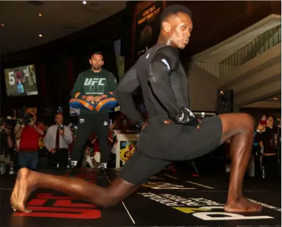  ?? Heidi Fang Las Vegas Review-journal @Heidifang ?? UFC middleweig­ht champion Israel Adesanya stretches Wednesday during UFC 248 open workouts at the MGM Grand.