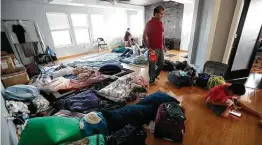  ?? Karen Warren / Staff photograph­er ?? Toriqul Islam stands in the middle of pallets in a large room inside Monirul Islam’s Katy home after he invited his relatives and others to stay Sunday.