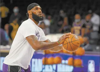  ?? JOHN MCCOY / AP ?? Lakers forward LeBron James (6) warms up before playing the Suns in a preseason NBA game in Los Angeles on Sunday.