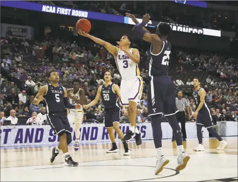  ?? Sam Greenwood / Getty Images ?? New Haven native Tremont Waters (3) of LSU takes a shot as Yale’s Miye Oni defends in the first half during the first round of the NCAA Tournament at VyStar Jacksonvil­le Veterans Memorial Arena Thursday.