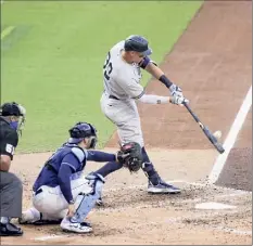  ?? Sean M. Haffey / Getty ?? The Yankees’ Aaron Judge hits a solo homer against the Rays in the fourth inning of Game 5 of the ALDS on Friday.