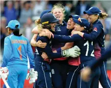  ?? AP ?? England’s Anya Shrubsole, centre, is hugged by teammates after her spell of 6-46 against India helped seal the World Cup