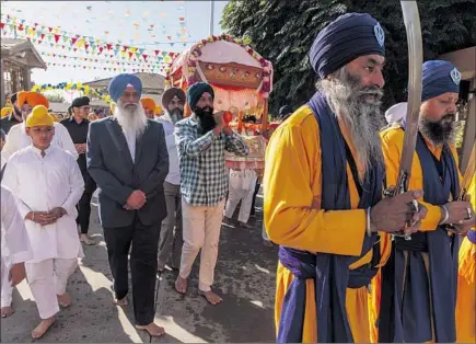  ?? SUKHWINDER ?? Singh Sidhu, in a suit, celebrates a Sikh spiritual leader’s birthday at Gurdwara Sahib, a Sikh temple in Stockton.