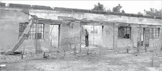  ?? Aminu Abubakar AFP/Getty Images ?? BOKO HARAM fighters stormed this college in Buni Yadi, Nigeria, in February 2014, killing at least 43 students as they slept and destroying the buildings.