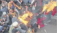  ?? REUTERS PHOTO ?? Congress party activists try to flee after their clothes caught fire while they were trying to burn an effigy of PM Narendra Modi during a protest in Shimla on Monday.