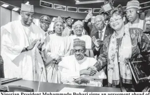  ??  ?? Nigerian President Muhammadu Buhari signs an agreement ahead of the lauching of the African Continenta­l Free Trade Area (AfCFTA), during African Union summit in Niamey, Niger July 7, 2019. Nigeria Presidency/Handout via Reuters