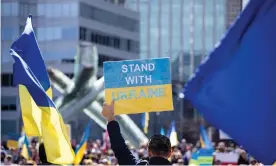  ?? Photograph: Ryan Walter Wagner/ZUMA Press Wire Service/REX/Shuttersto­ck ?? A person holds a sign reading ‘stand with Ukraine’ at a rally in Vancouver last week.