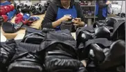  ?? SUSANA GONZALEZ/ BLOOMBERG ?? A worker performs a quality check on a boxing glove at the Cleto Reyes manufactur­ing facility in Ecatepec, Mexico. The country is part of the NAFTA trade agreement.
