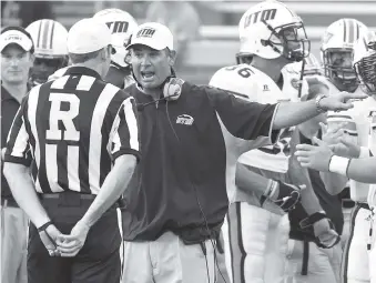  ?? STAFF PHOTO BY DOUG STRICKLAND ?? UT-Martin coach Jason Simpson shouts at a referee during a 2013 game against UTC at Finley Stadium. UTM’s Skyhawks won that game. Simpson previously worked for UTC.