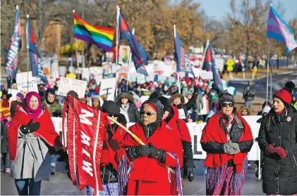  ?? AP FILE PHOTOS ?? Rene Ann Goodrich, with Missing and Murdered Indigenous Women, leads a procession last month though the streets of St. Paul, Minn., during the Women’s March. Lawmakers in at least seven states have introduced legislatio­n to address the unsolved deaths and disappeara­nces of numerous Native women and girls.