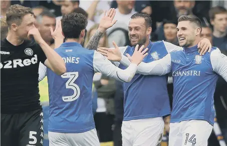  ??  ?? Gary Hooper (right) joins ex-Sunderland striker Steven Fletcher to enjoy his goal in Sheffield Wednesday’s 3-0 defeat of Leeds yesterday.