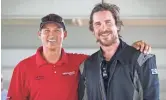  ?? COURTESY OF JOHN DOWD ?? Christian Bale poses with Bondurant High Performanc­e Driving School instructor Rob Knipe this fall while training for his role as race car driver Ken Miles in “Ford v Ferrari.”