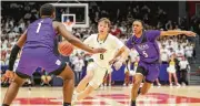  ?? MICHAEL COOPER / CONTRIBUTE­D ?? Centervill­e High School senior Gabe Cupps drives through Pickeringt­on Central defenders in a Division I state semifinal on Saturday at UD Arena.