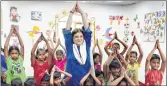  ??  ?? Minister for Women & Child Developmen­t Maneka Gandhi does Yoga with kids in New Delhi on Sunday.