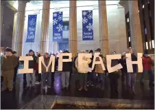  ?? PETE BANNAN - MEDIANEWS GROUP ?? Rallygoers spell out ‘impeach’ on the steps of the historic Chester County Courthouse Tuesday evening.