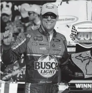  ?? Paul Sancya, The Associated Press ?? Kevin Harvick celebrates his victory Sunday in the Consumers Energy 400 at Michigan Internatio­nal Speedway in Brooklyn, Mich.