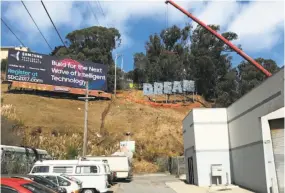  ?? Ana Teresa Fernández ?? “DREAM,” in shimmering 12-foot-high letters, is installed with a crane on the east-facing slope of Bernal Hill in San Francisco. The artwork by Ana Teresa Fernández, an immigrant from Mexico, was commission­ed by the Yerba Buena Center under the Civic...