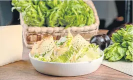  ??  ?? Caesar salad showcasing two protected designatio­n of origin Italian cheeses.