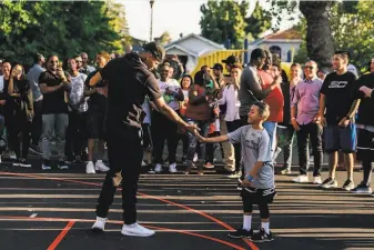  ?? Photos courtesy of Under Armour ?? Kids, including this recent camp participan­t, tend to feel the love when around Stephen Curry.